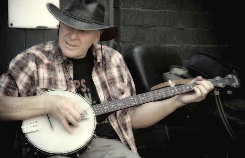 Seated cowboy playing.