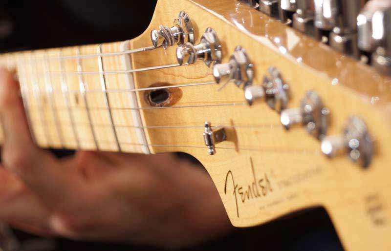 Male musician playing guitar.