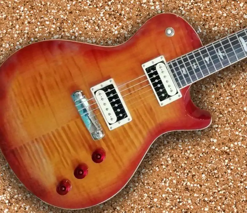 Cherry sunburst PRS SE Bernie Marsden electric guitar body showing flame maple top, Zebra humbuckers, and bird inlays.