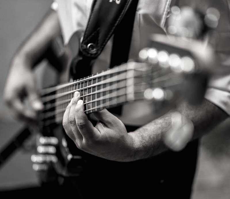 Male musician playing guitar.